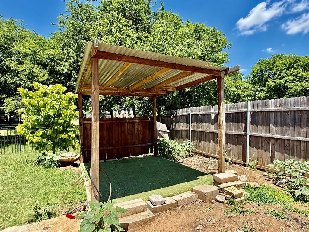 1144 Switchgrass Lane Crowley, TX 76036 - Photo 14 of 17 a view of a backyard with a small cabin