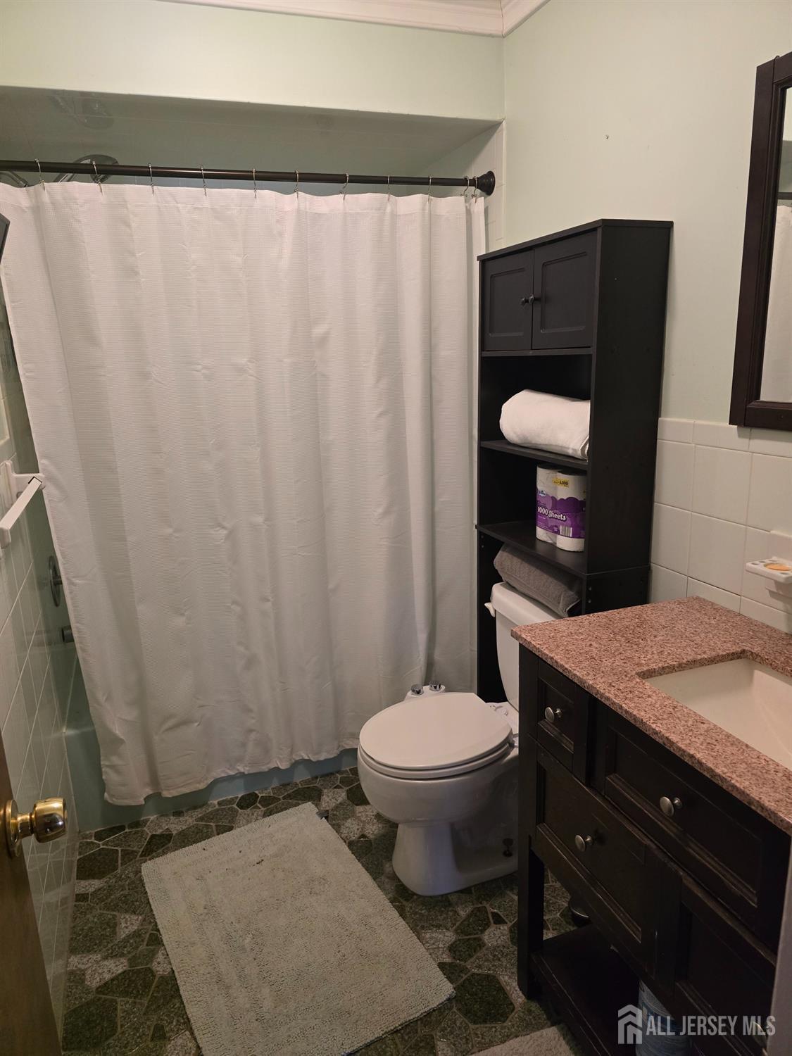 241 Monmouth Road Freehold, NJ 07728 - Photo 12 of 30 a bathroom with a granite countertop sink toilet and a mirror