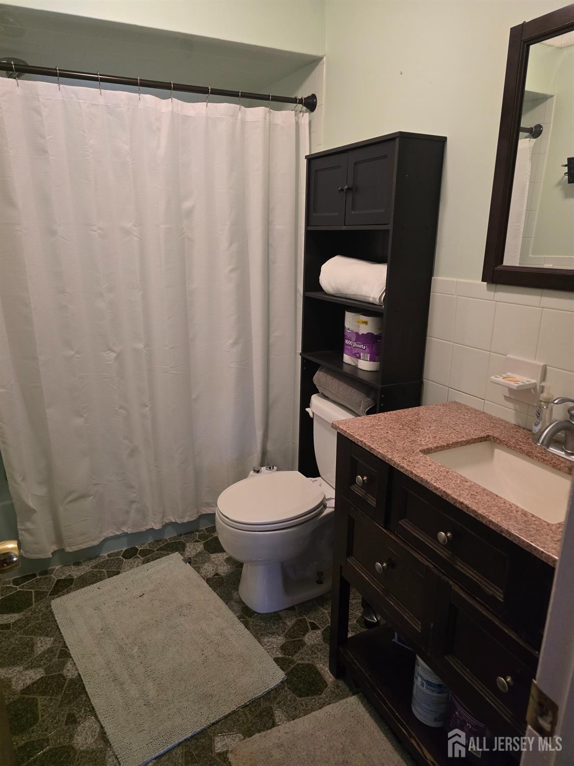 241 Monmouth Road Freehold, NJ 07728 - Photo 13 of 30 a bathroom with a granite countertop sink toilet and mirror