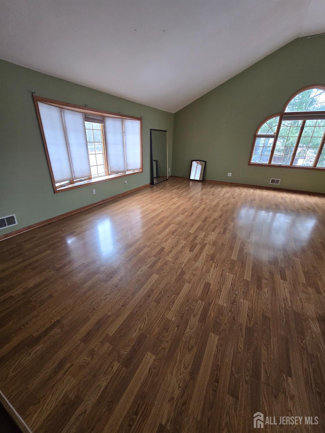 241 Monmouth Road Freehold, NJ 07728 - Photo 16 of 30 a view of wooden floor and windows in a room