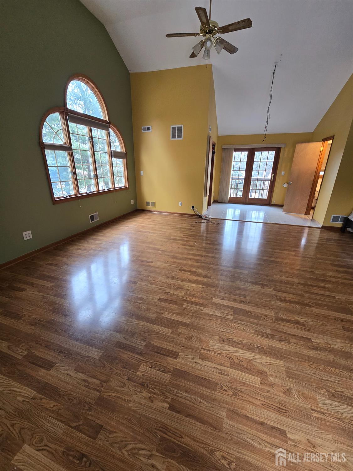 241 Monmouth Road Freehold, NJ 07728 - Photo 18 of 30 an empty room with wooden floor fan and windows