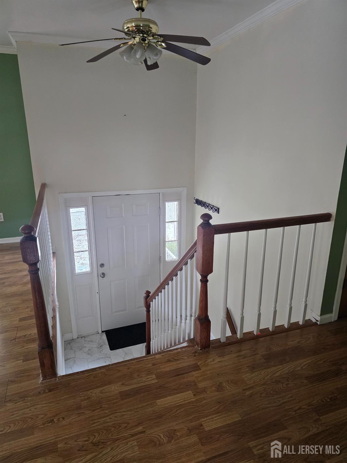241 Monmouth Road Freehold, NJ 07728 - Photo 5 of 30 a view of a hallway with wooden floor and staircase