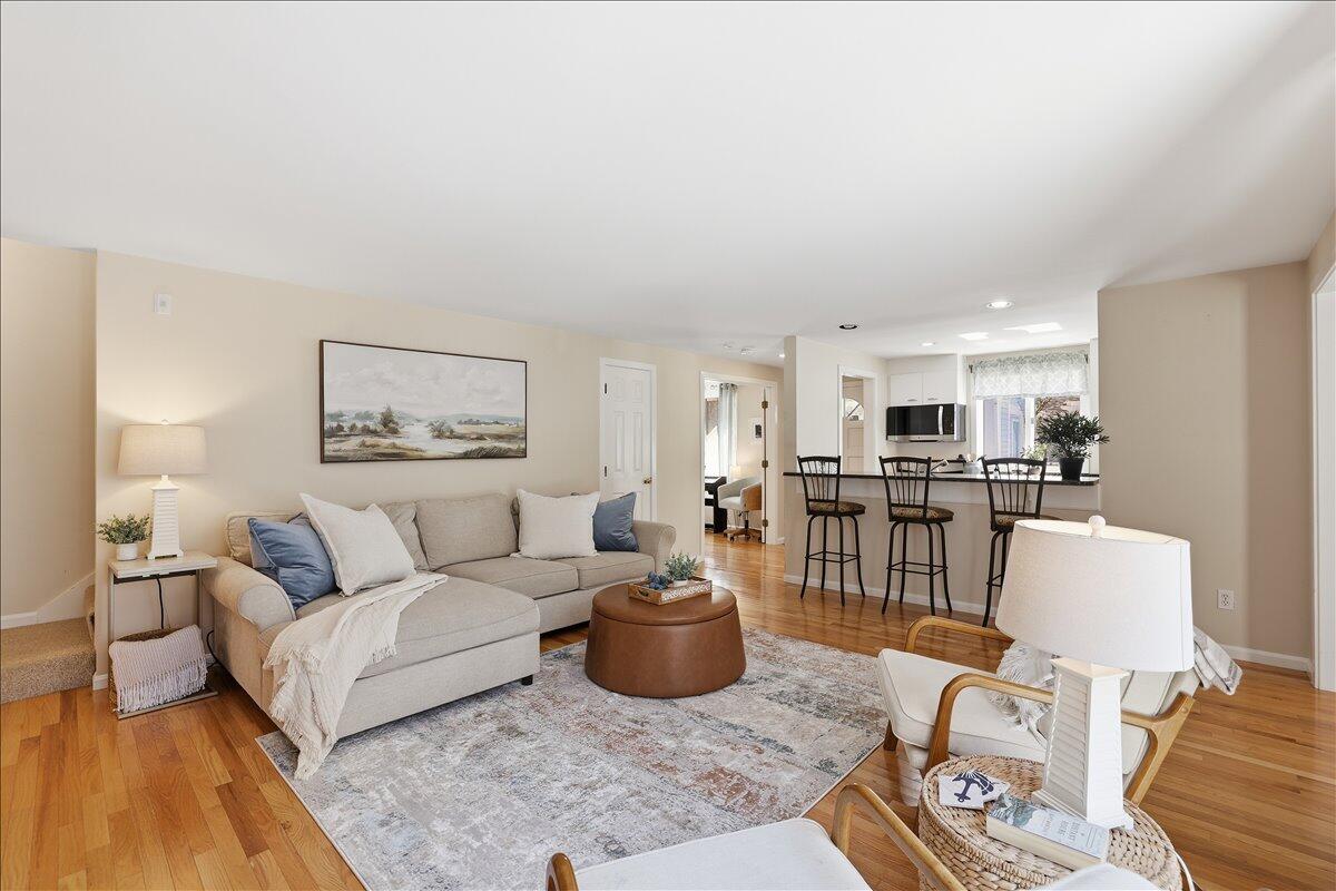 100 Mid-Iron Way, Unit 7027 Mashpee, MA 02649 - Photo 7 of 38 a living room with furniture a rug and kitchen view