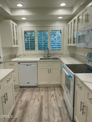 a kitchen that has a sink and a stove in it