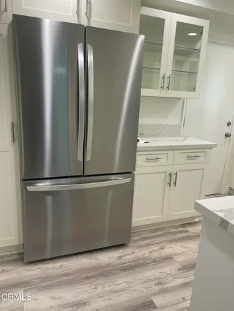 a refrigerator freezer sitting inside of a kitchen