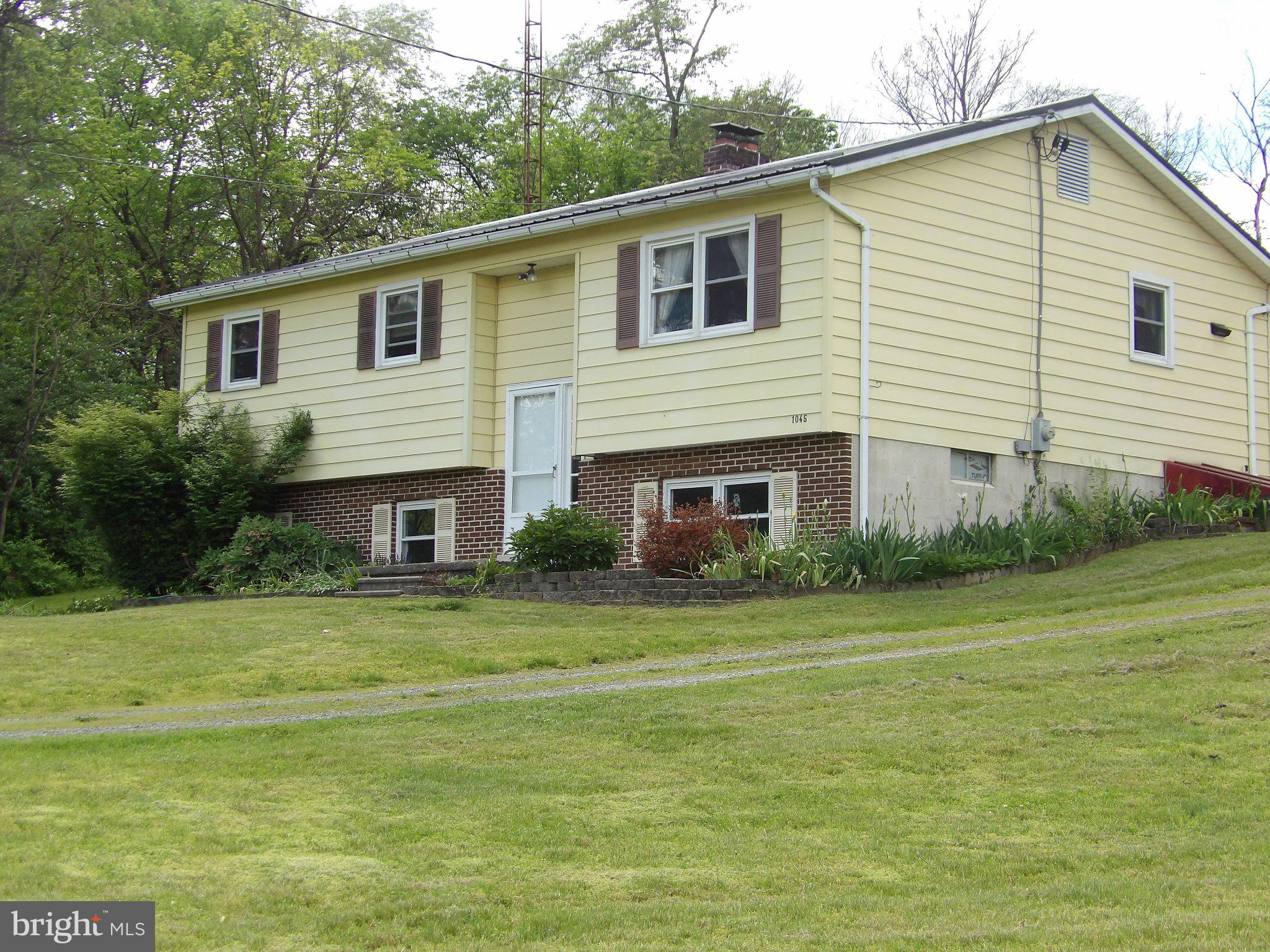 1045 Lockport Road Lewistown, PA 17044 - Photo 25 of 51 Charming hillside home with lush greenery.