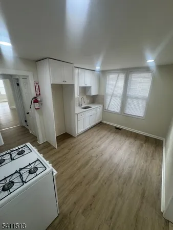 a kitchen with a wooden floor and a stove top oven