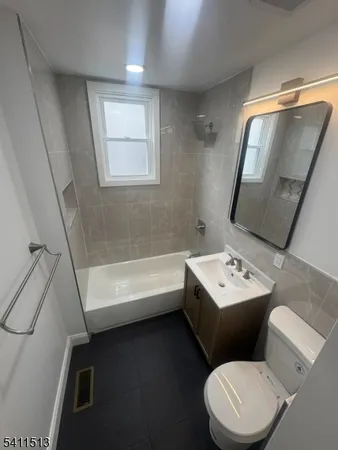 a bathroom with a sink toilet and tub