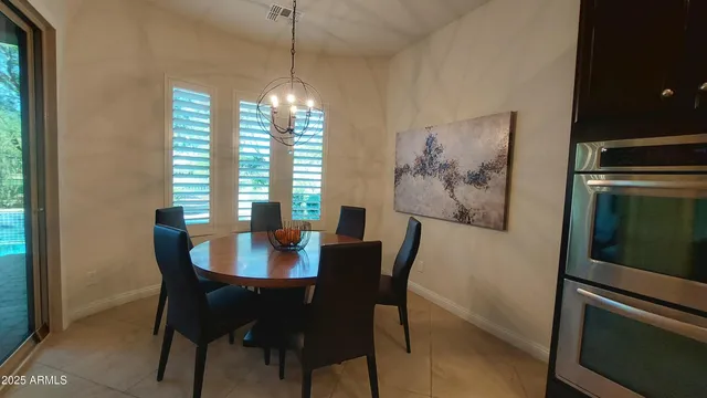 a kitchen with a table and chairs in it