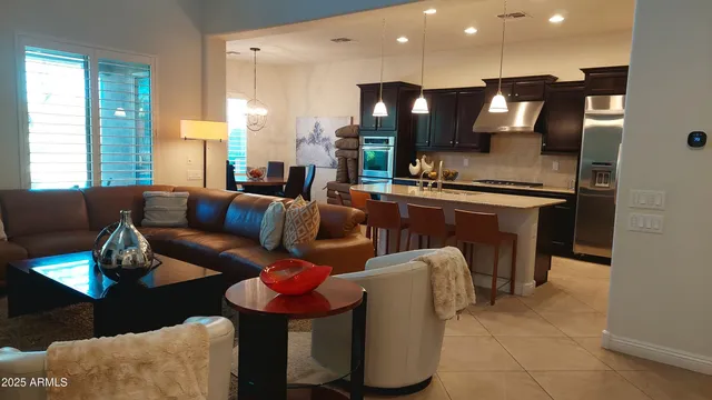 a kitchen with stainless steel appliances granite countertop a sink refrigerator and microwave