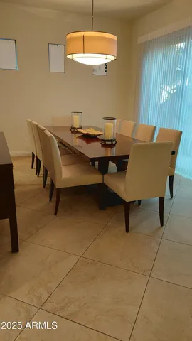 a view of a hallway of a livingroom with furniture and windows