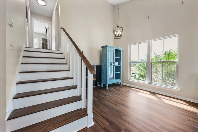 a view of entryway and hall with wooden floor