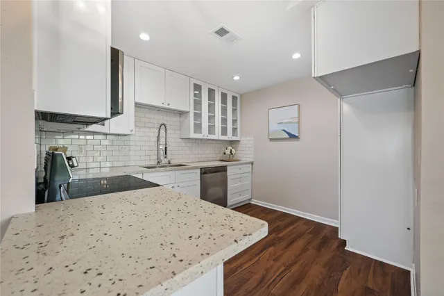 a kitchen with sink cabinets and wooden floor