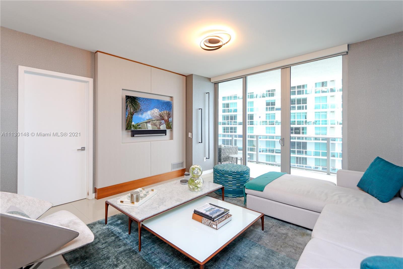 Edgewater Miami, FL 33132 - Photo 11 of 13 a living room with furniture and a large window