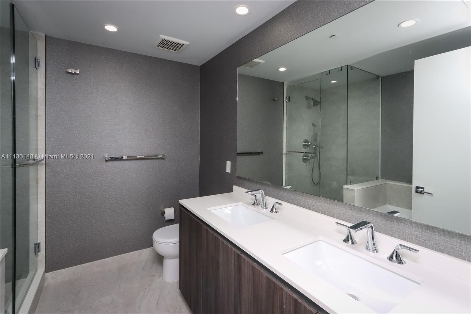 Edgewater Miami, FL 33132 - Photo 12 of 13 a bathroom with a sink double vanity and a toilet