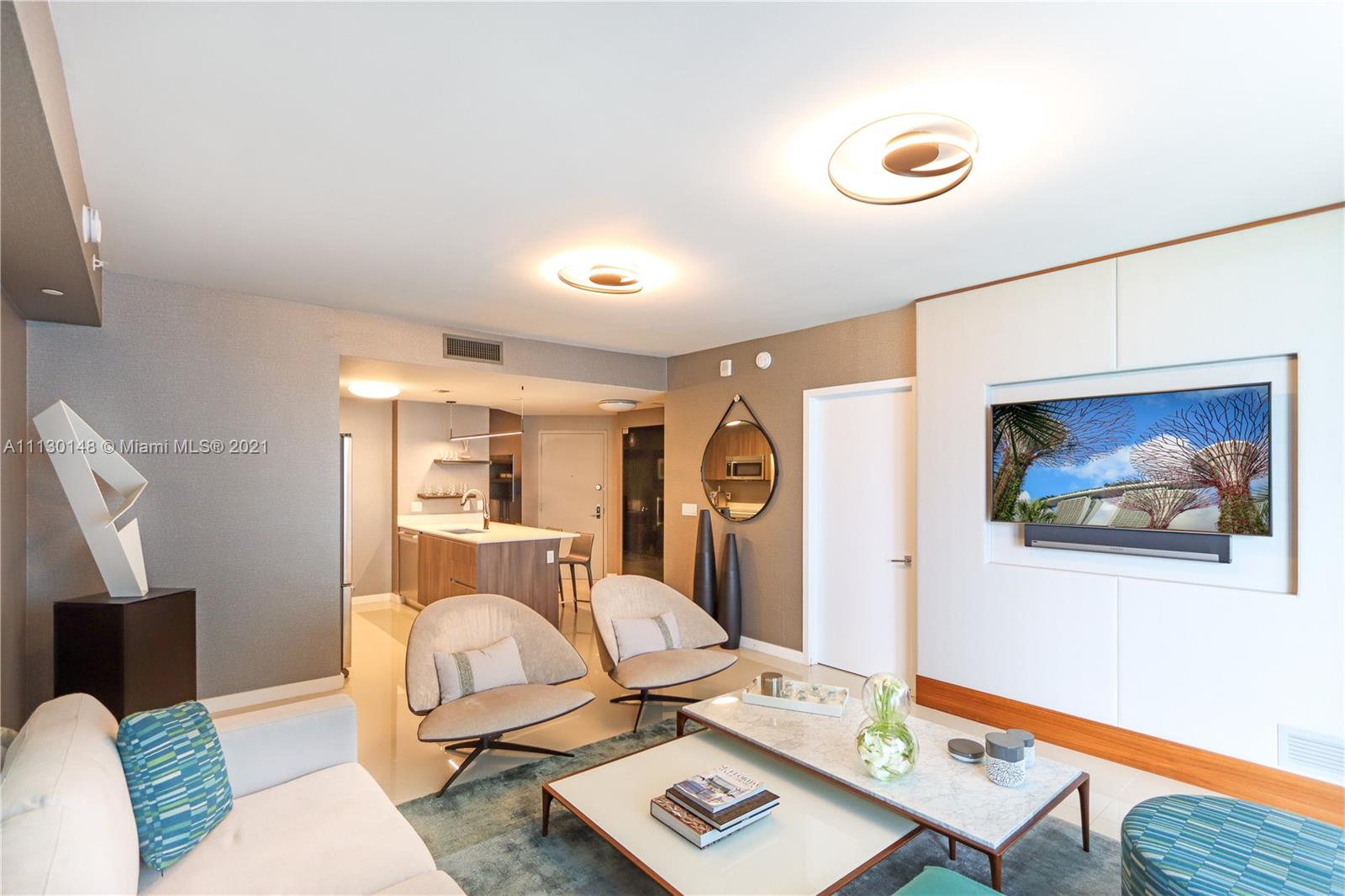 Edgewater Miami, FL 33132 - Photo 2 of 13 a bedroom with furniture and a wooden floor