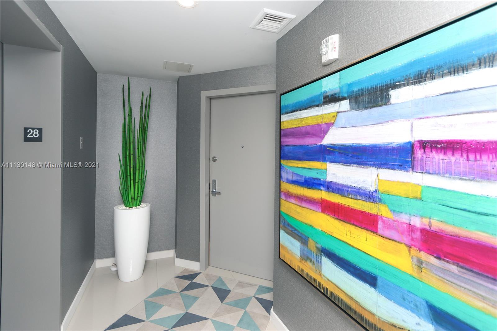 Edgewater Miami, FL 33132 - Photo 5 of 13 a room that has a rug and a plant in it