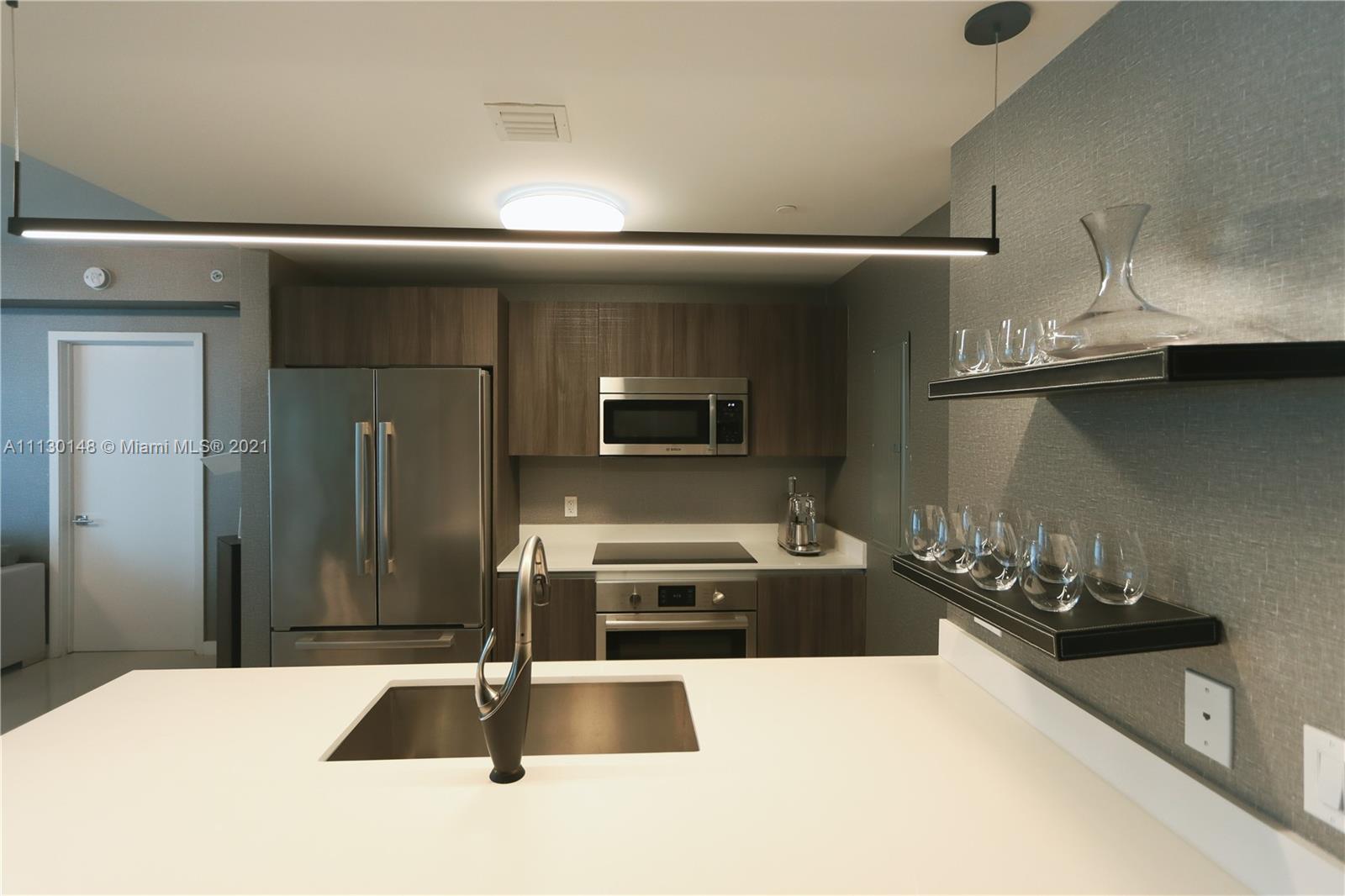 Edgewater Miami, FL 33132 - Photo 9 of 13 a kitchen with stainless steel appliances a sink and a microwave