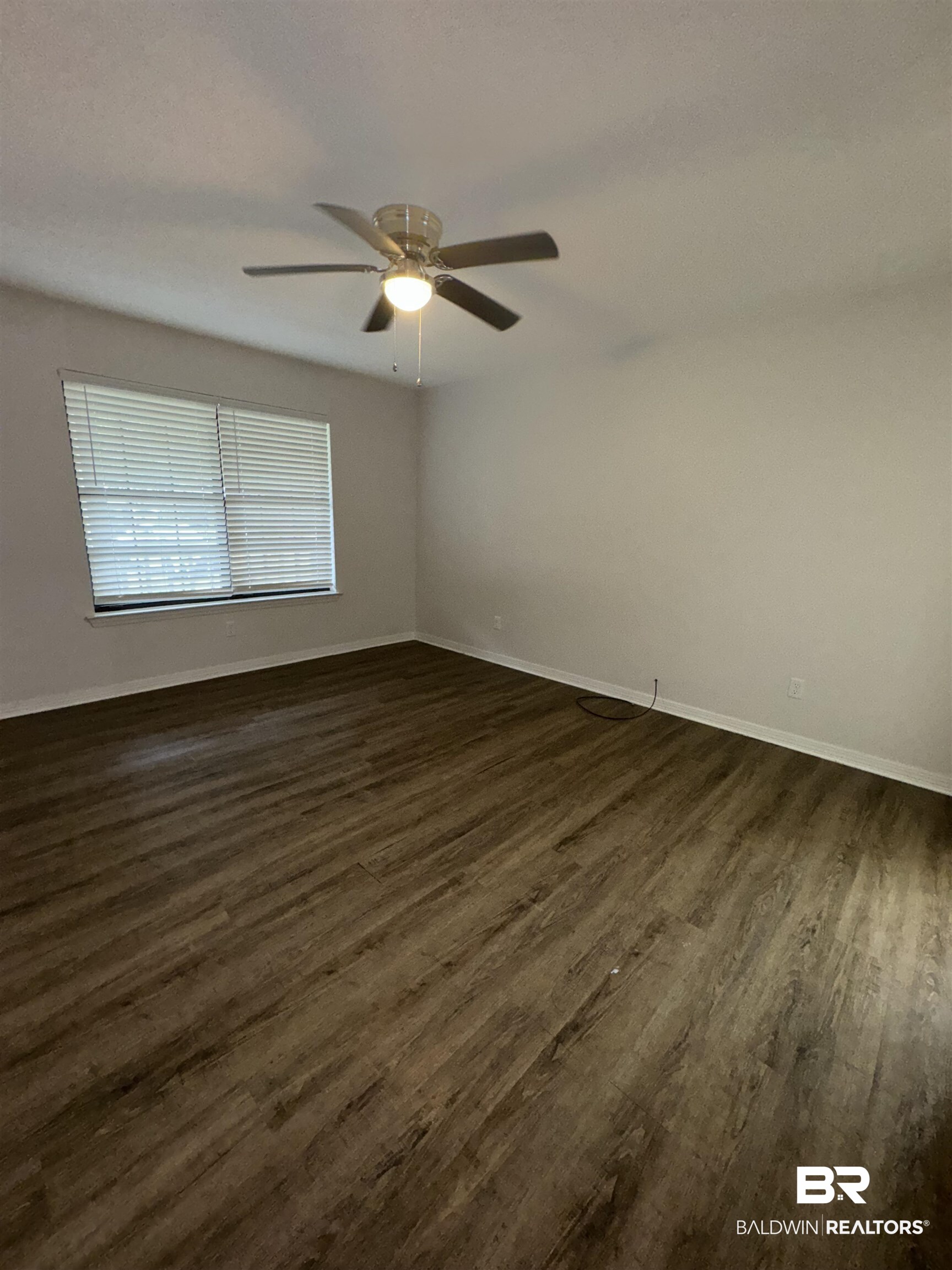70 Plum Street Uriah, AL 36480 - Photo 11 of 36 Empty room featuring dark hardwood / wood-style floors and ceiling fan