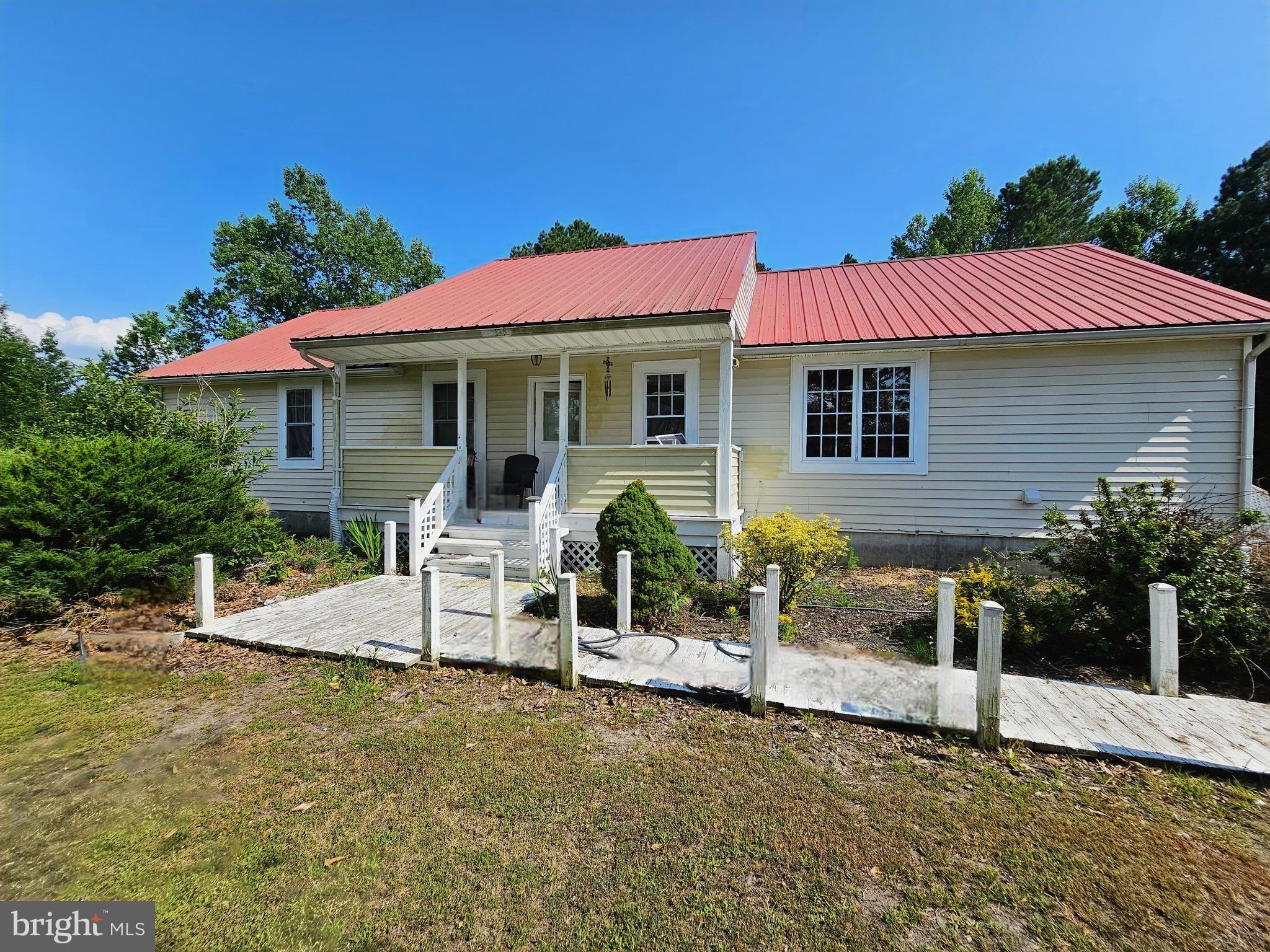 a view of a house with backyard sitting area and garden