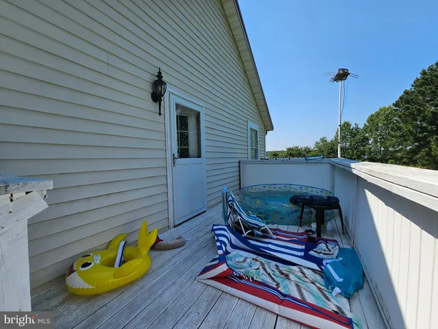a roof deck with wooden floor and fence