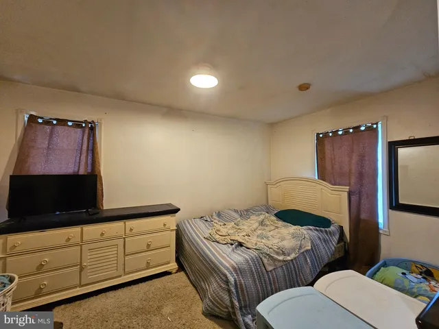 a bedroom with a bed and a flat screen television