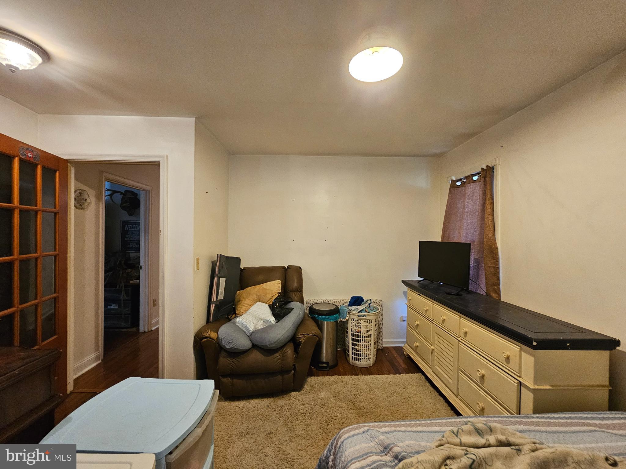 8909 Arden Station Road Westover, MD 21871 - Photo 17 of 32 a bedroom with furniture and a flat screen tv