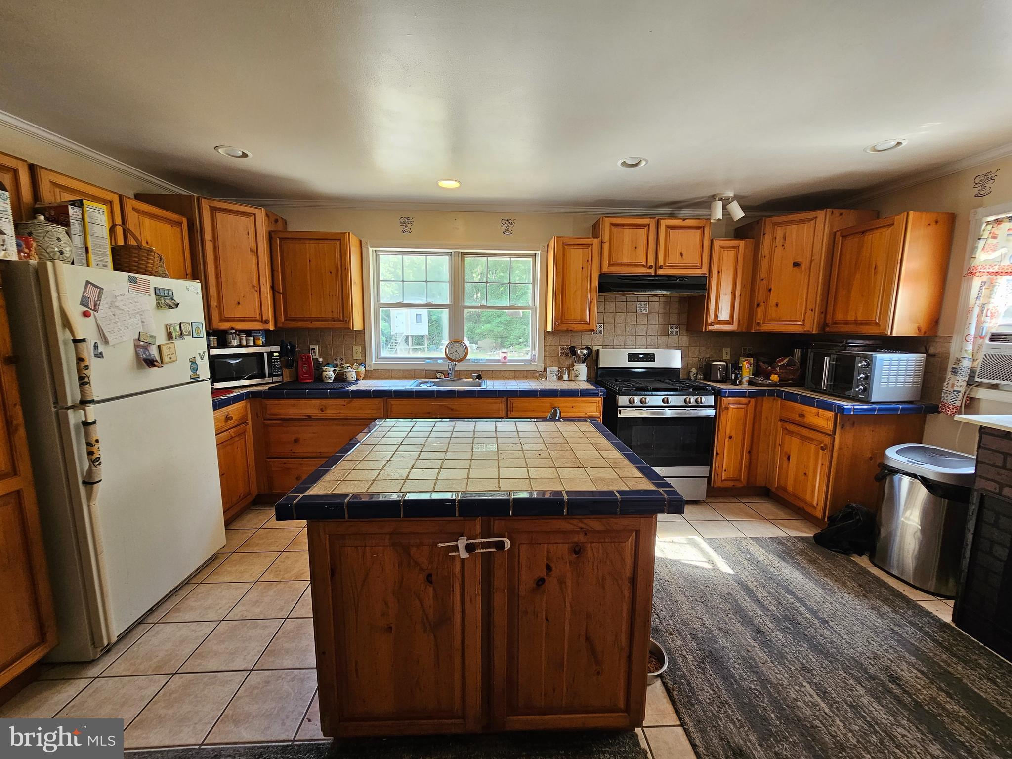 8909 Arden Station Road Westover, MD 21871 - Photo 2 of 32 a kitchen with granite countertop a refrigerator a sink dishwasher a stove with wooden cabinets and floor
