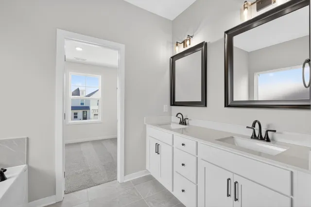 a bathroom with double sink and a mirror