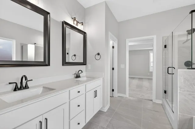 a bathroom with a double vanity sink and mirror