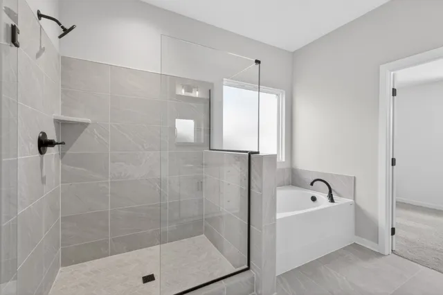 a bathroom with a bathtub and shower