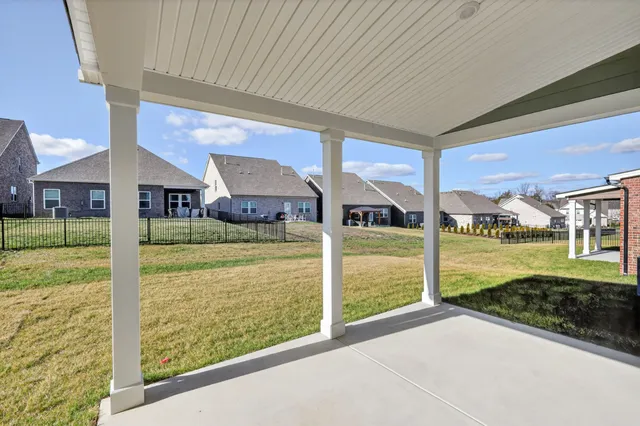 a view of a house with a yard and sitting area