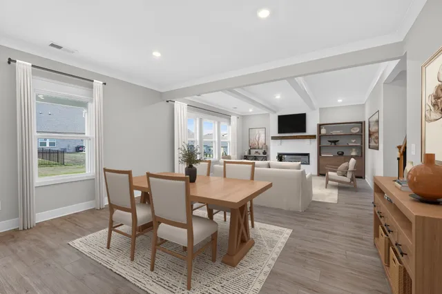 a view of a dining room with furniture window and wooden floor