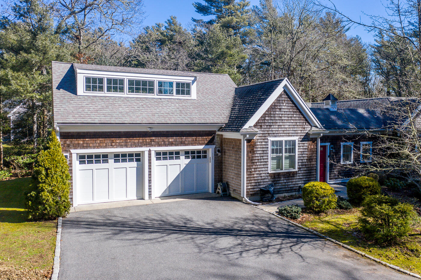 125 Woodside Road West Barnstable, MA 02668 - Photo 6 of 58 a front view of a house with a yard and garage