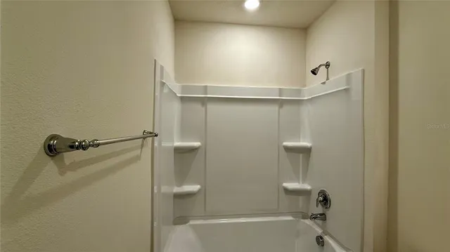 a bathroom with a shower and a toilet
