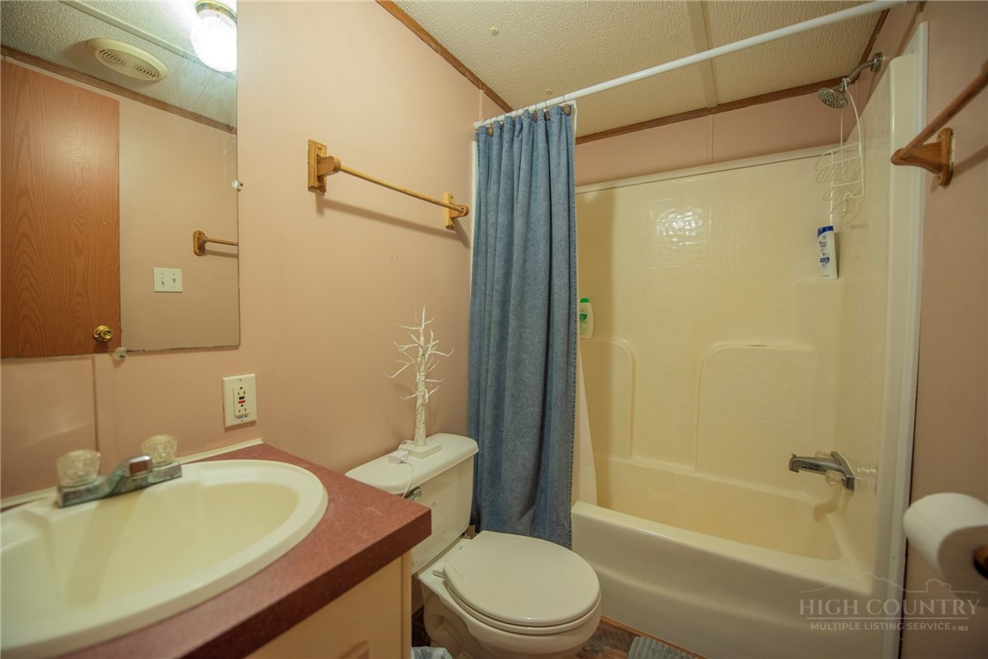 1848 West Mill Creek Road Warrensville, NC 28693 - Photo 41 of 50 a bathroom with a sink toilet and shower