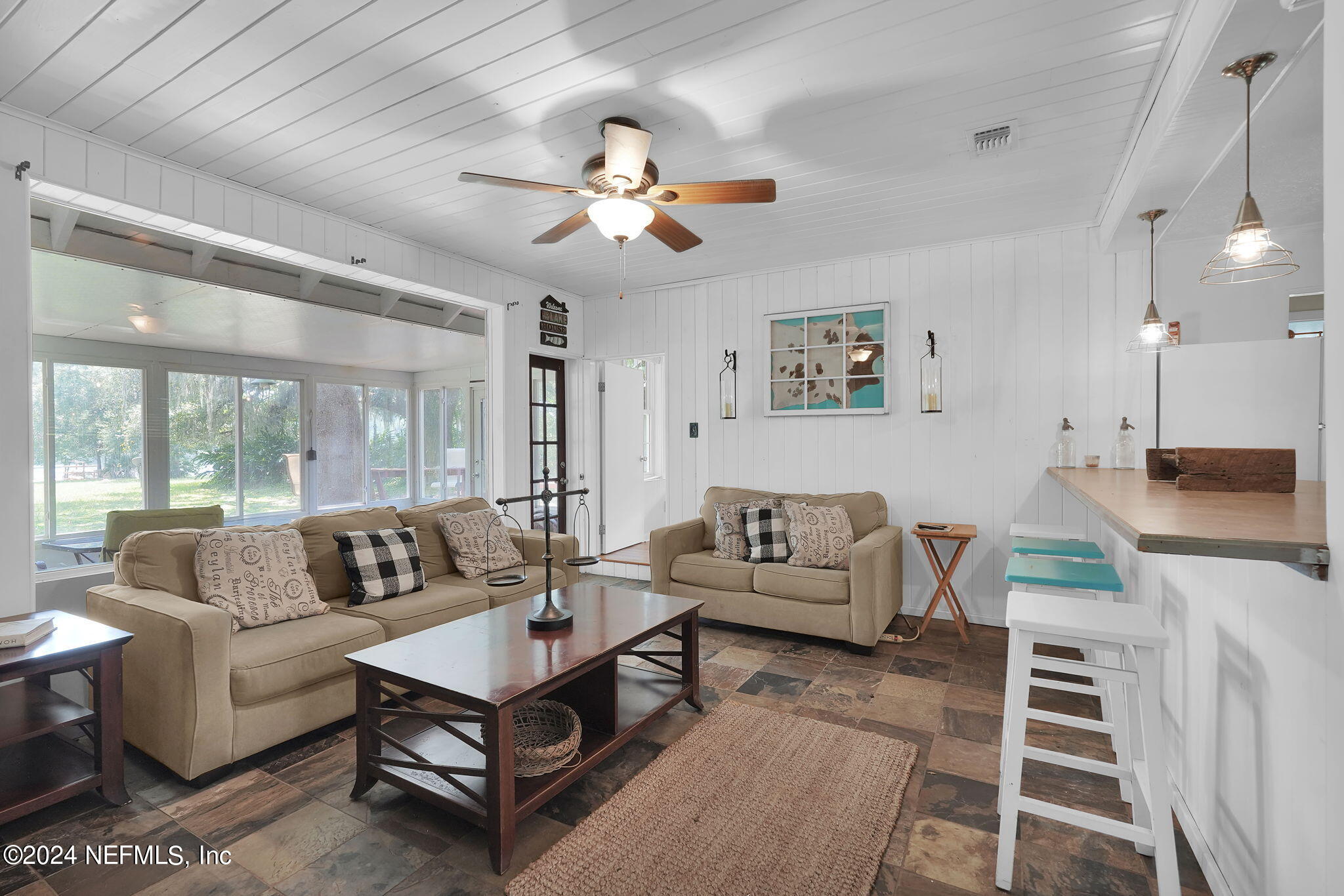 25 Forest Street Keystone Heights, FL 32656 - Photo 11 of 22 a living room with furniture a ceiling fan and a rug