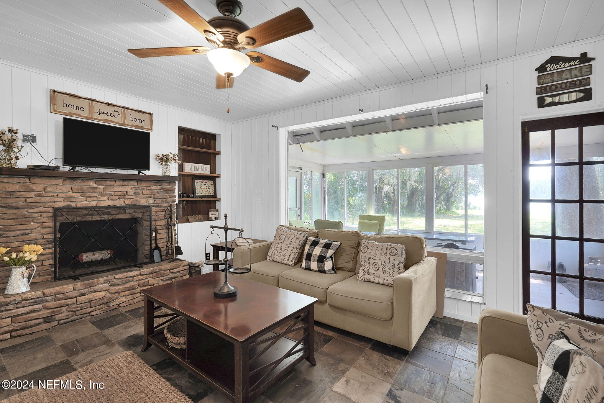 25 Forest Street Keystone Heights, FL 32656 - Photo 14 of 22 a living room with furniture a flat screen tv and a fireplace
