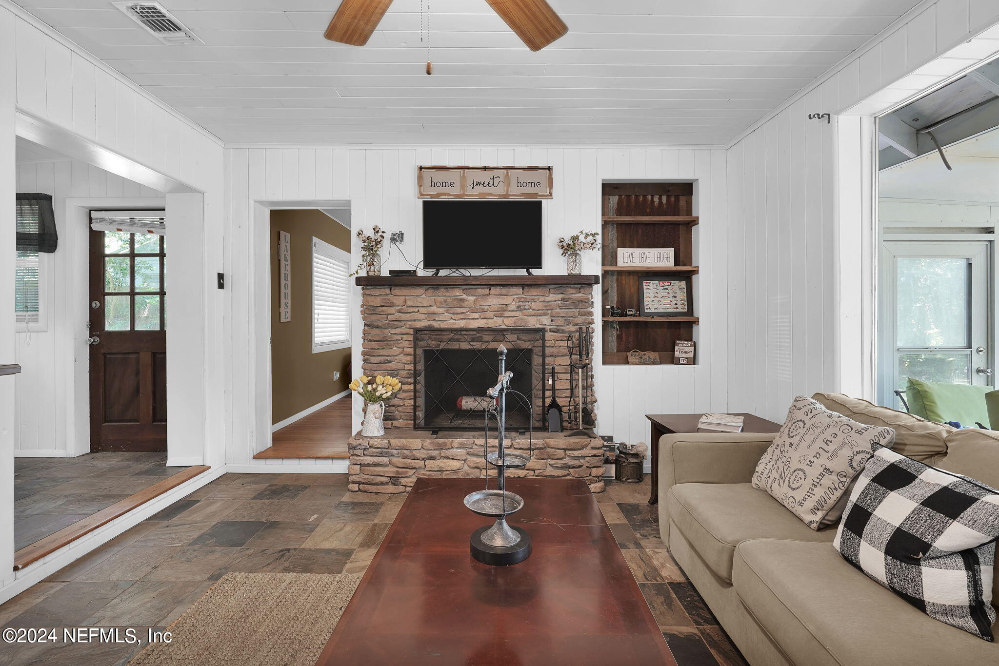 25 Forest Street Keystone Heights, FL 32656 - Photo 15 of 22 a living room with furniture a flat screen tv and a fireplace