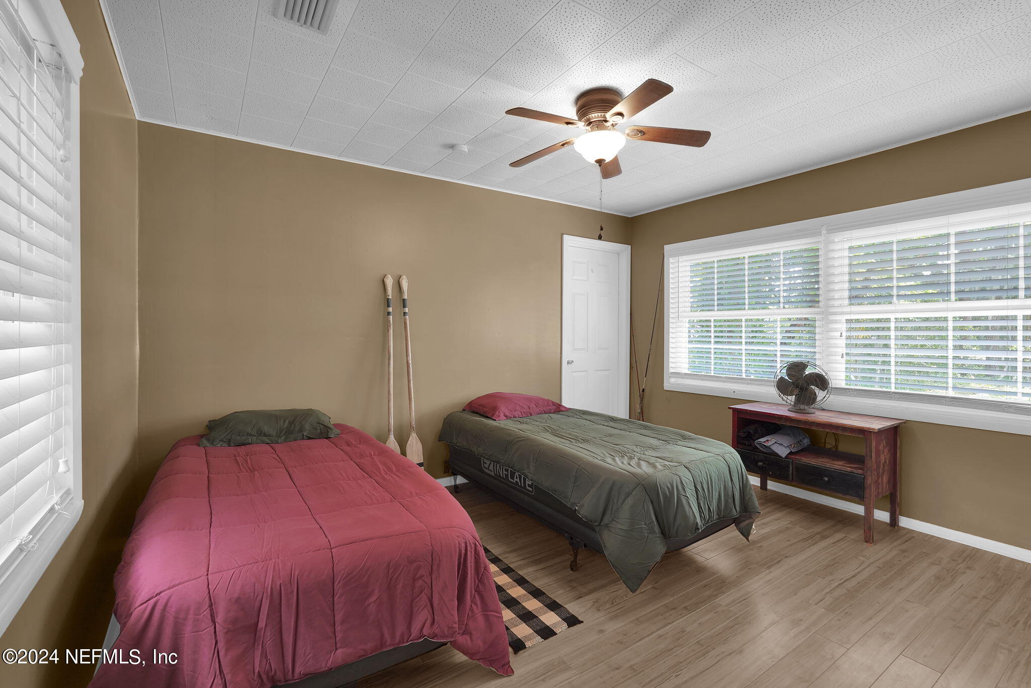 25 Forest Street Keystone Heights, FL 32656 - Photo 16 of 22 a bedroom with two beds and a chandelier
