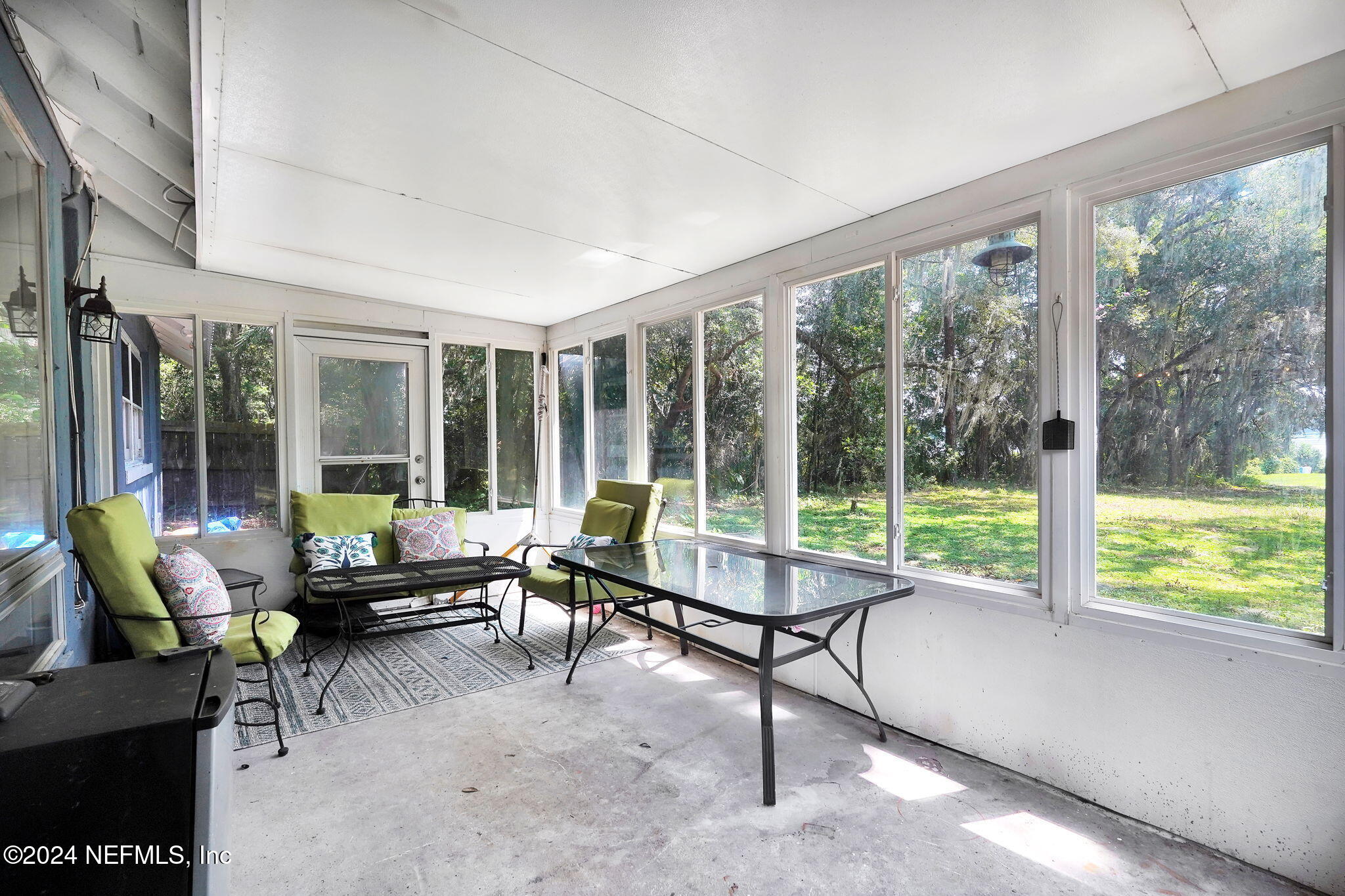 25 Forest Street Keystone Heights, FL 32656 - Photo 18 of 22 a living room with furniture and floor to ceiling windows