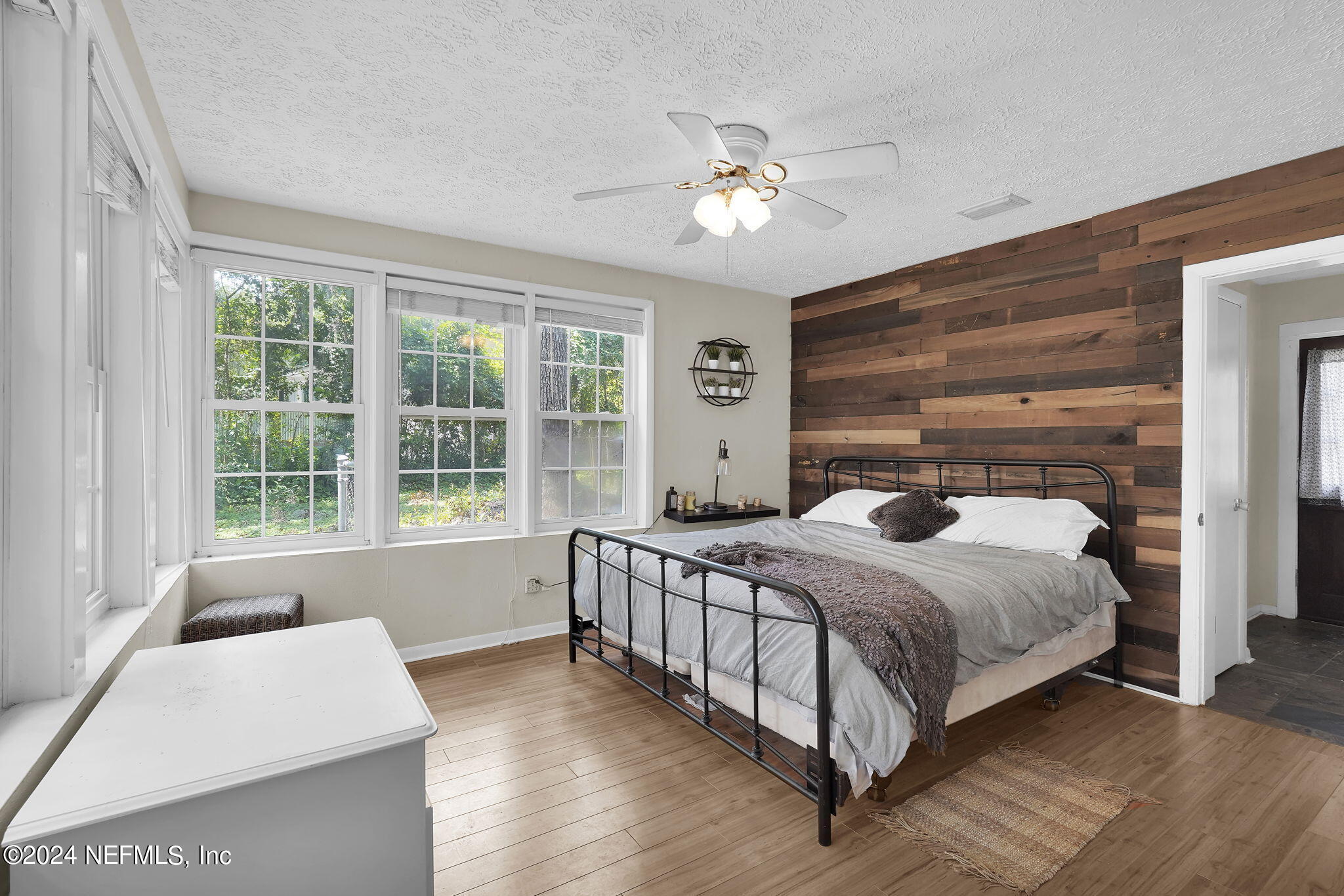 25 Forest Street Keystone Heights, FL 32656 - Photo 5 of 22 a bedroom with a large bed and a chandelier