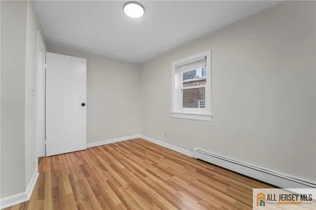 a view of a room with wooden floor and white walls