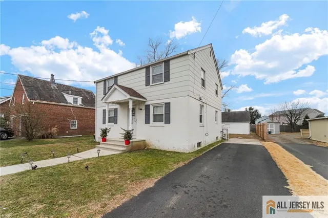 a view of a white house with a yard