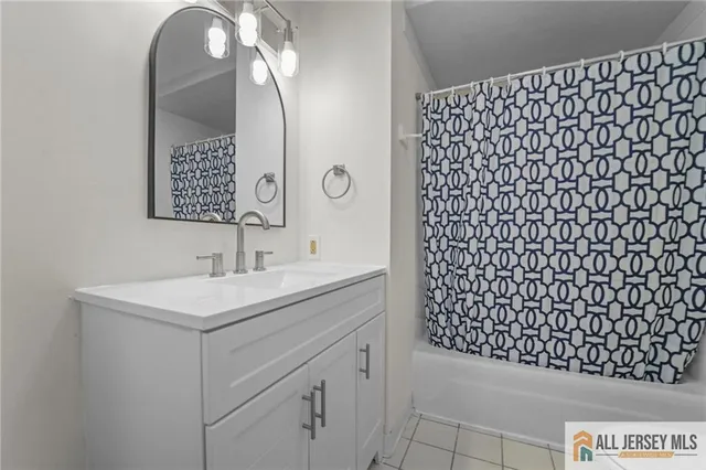 a bathroom with a sink a vanity and a shower