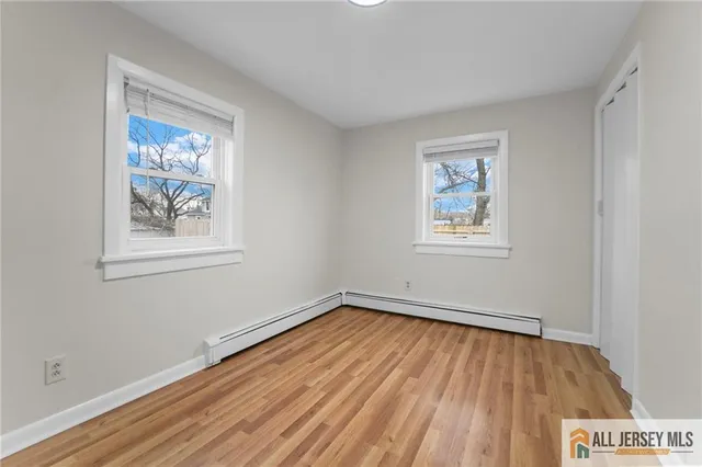 a view of room with window and wooden floor