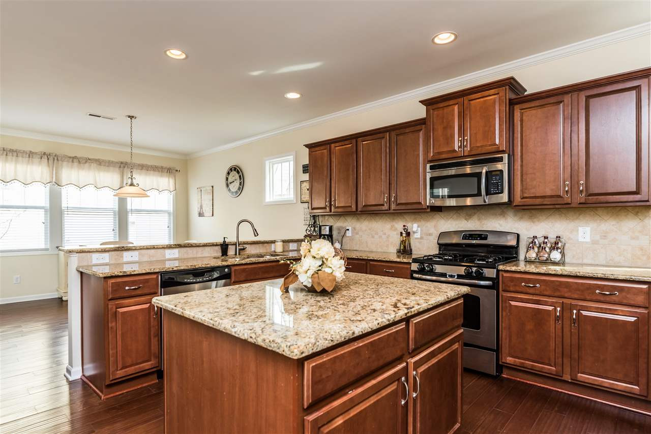 1413 Van Page Boulevard Raleigh, NC 27607 - Photo 7 of 25 GREAT SEATING OPTIONS IN THIS KITCHEN WITH A BUILT IN DESK AND LONG BAR FOR GUESTS! KITCHEN