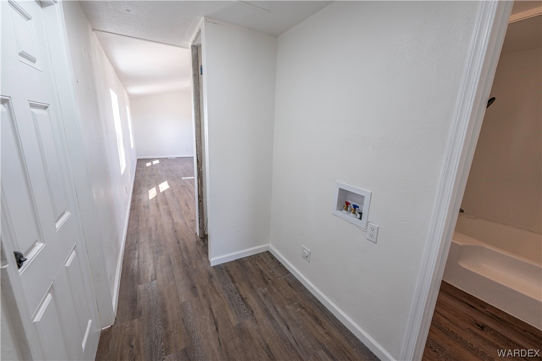 2337 South Canelo Road Golden Valley, AZ 86413 - Photo 12 of 30 a view of a hallway with wooden floor and a bathroom