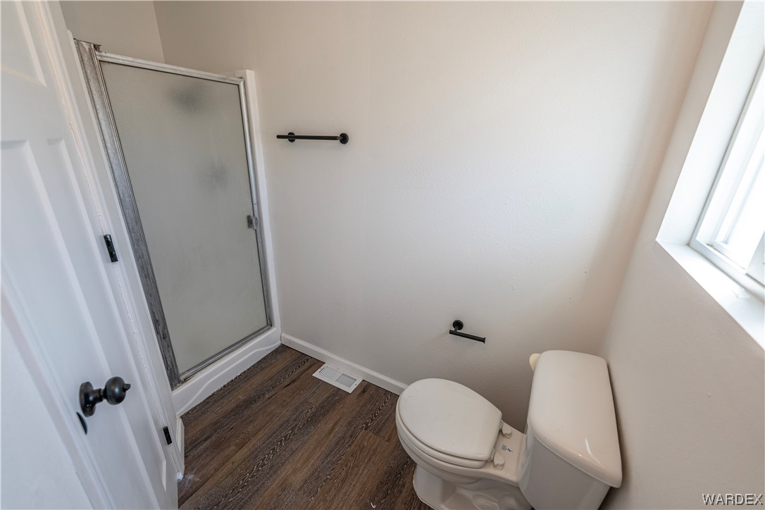 2337 South Canelo Road Golden Valley, AZ 86413 - Photo 14 of 30 a white toilet sitting next to a window