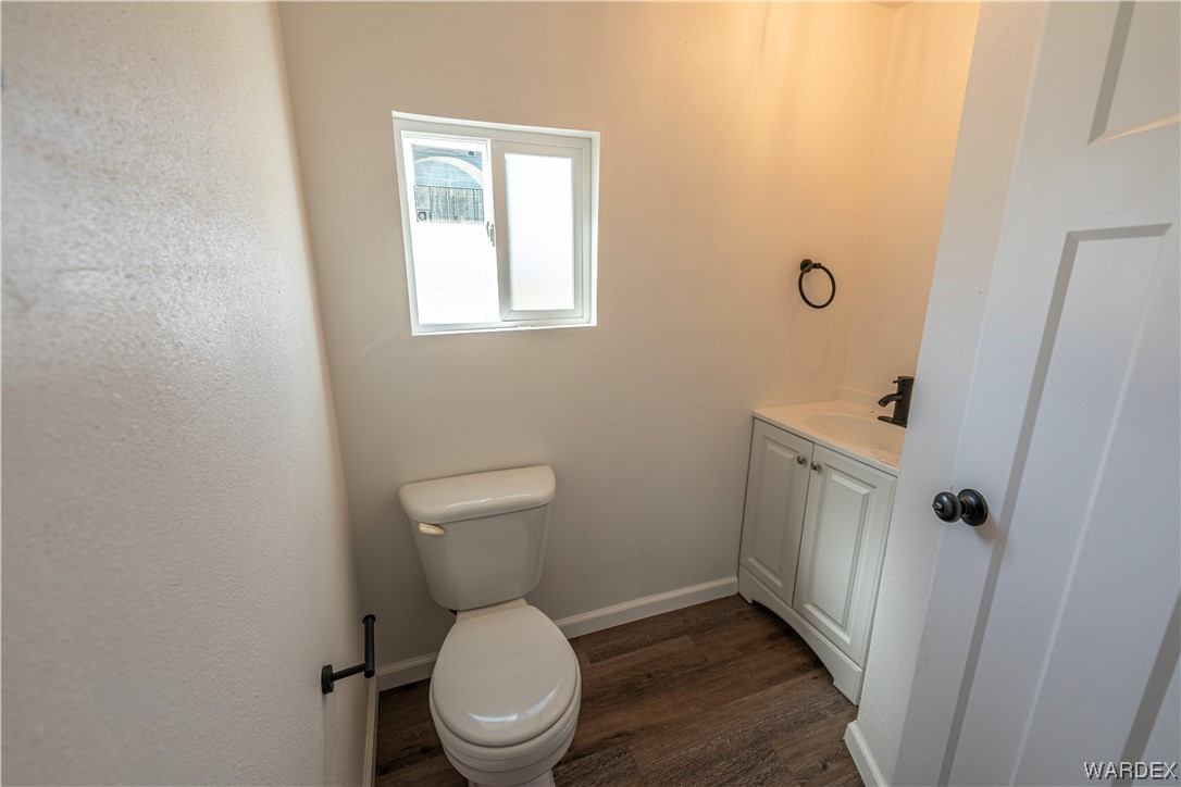 2337 South Canelo Road Golden Valley, AZ 86413 - Photo 16 of 30 a white toilet sitting in a bathroom next to a sink